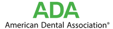 The image shows a logo with text that reads ADA at the top, followed by AMERICAN DENTAL ASSOCIATION. Below this, there s a stylized letter A inside a square, and beneath that, the words AMERICAN DENTAL ASSOCIATION are repeated. The logo has a color scheme of green, white, and black.