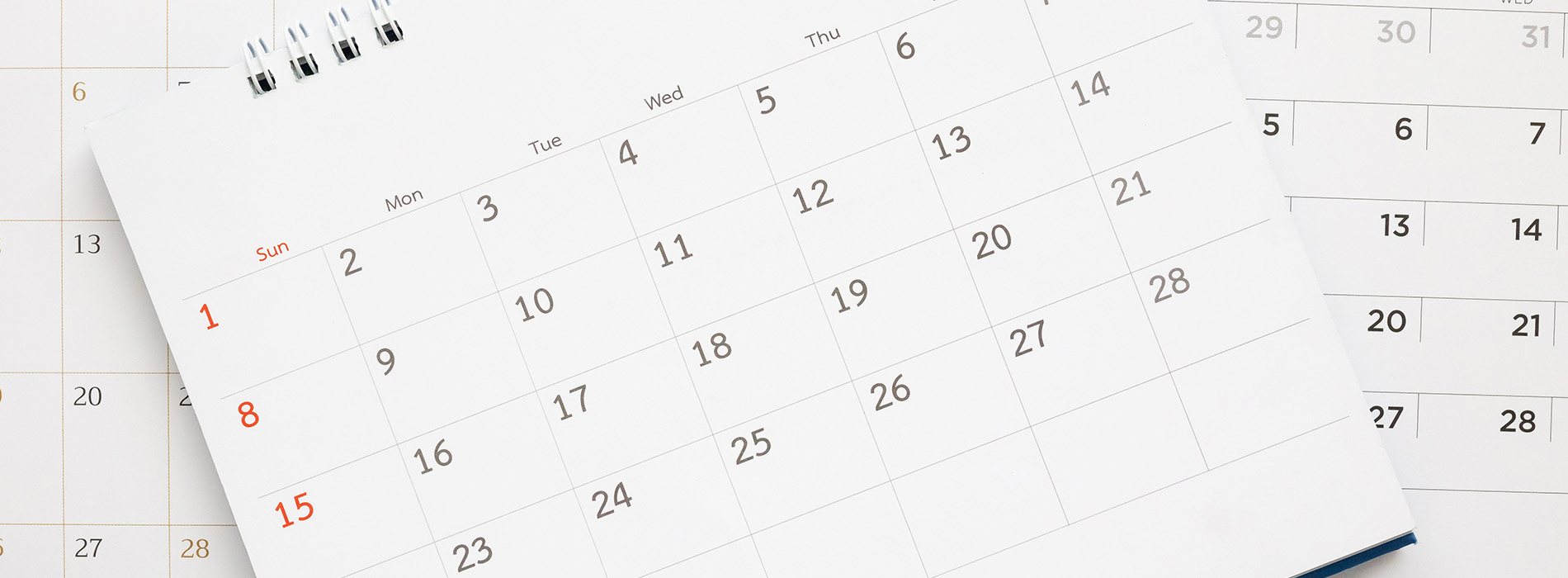 The image shows a printed calendar with dates from April to July 2023, placed next to a digital calendar displaying the same period, both set against a neutral background.